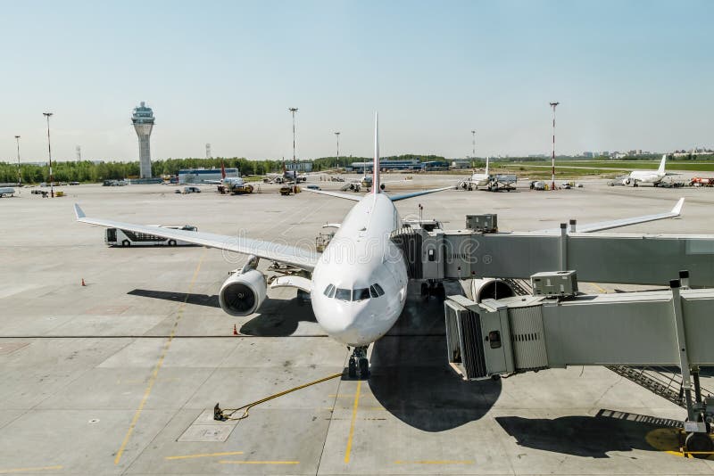 May 31, 2015.Saint Petersburg.Russia. Plane with boarding ramp at the airport Pulkovo. May 31, 2015.Saint Petersburg.Russia. Plane with boarding ramp at the airport Pulkovo.