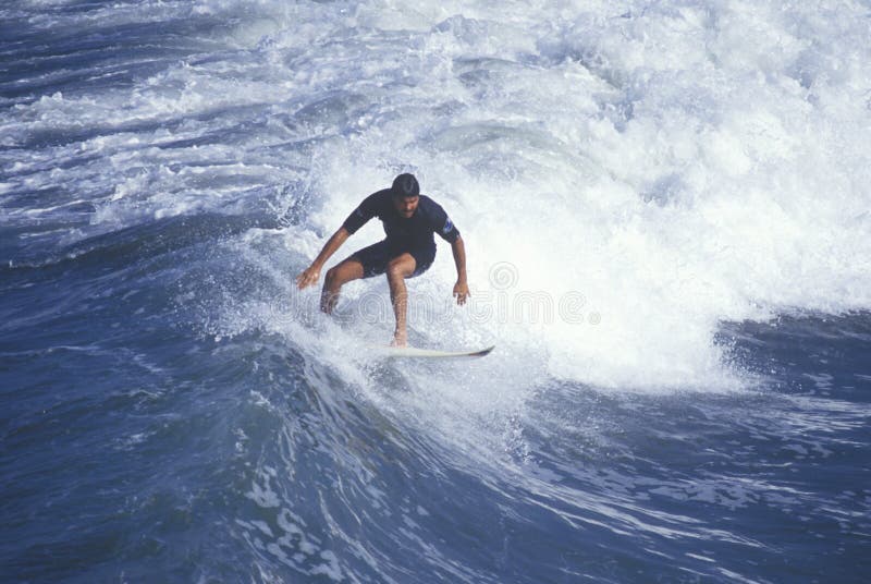 Surfer on crest of wave, Huntington Beach, CA stock image