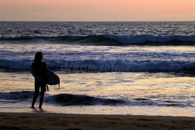 A Surfer Girl at Sunset.