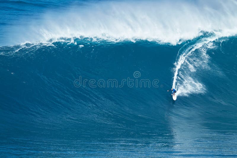 MAUI, HI - JANUARY 16 2016: Professional surfer Shane Dorian rides a giant wave at the legendary big wave surf break known as Jaws on one the largest swells of the year. MAUI, HI - JANUARY 16 2016: Professional surfer Shane Dorian rides a giant wave at the legendary big wave surf break known as Jaws on one the largest swells of the year.