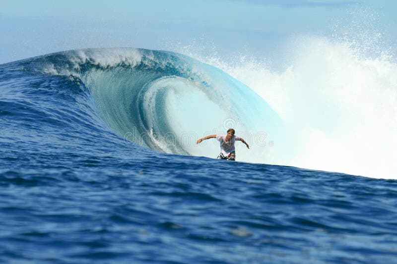 Surfer riding in barrel on perfect wave