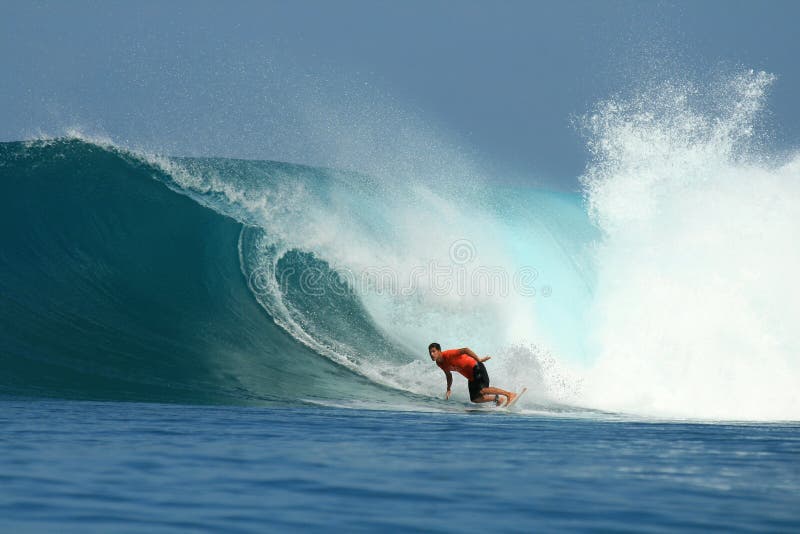 Surfer riding blue wave, Mentawai, Indonesia