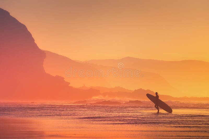 Surfer silhouette at sunset