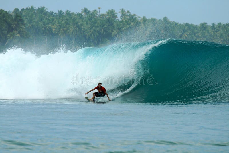 Surfer turning off bottom on big wave, Mentawai Is