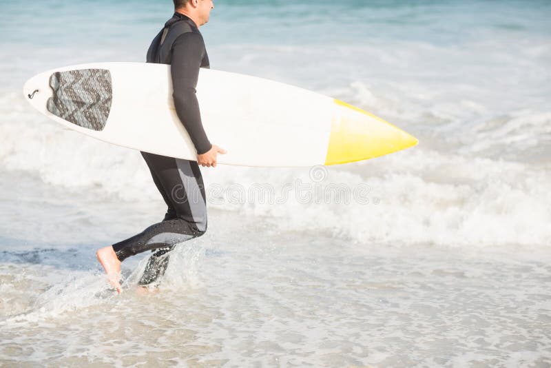 Surfer Walking on the Beach with a Surfboard Stock Image Image of