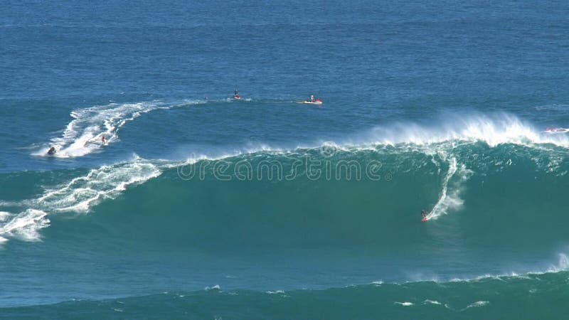 Surfers and jetski at the big wave surfing break jaws at the north shore of the island of Maui, Hawaii