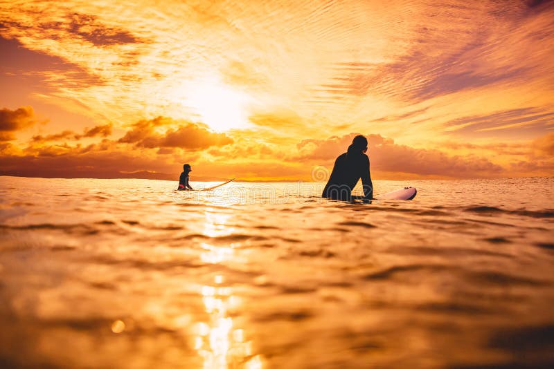 Sporty Surf Woman in Sea at Sunset or Sunrise. Winter Surfing in Ocean ...