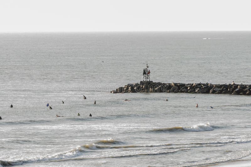 Surfers in the Ocean Surf at Virginia Beach, VA Editorial Stock Image