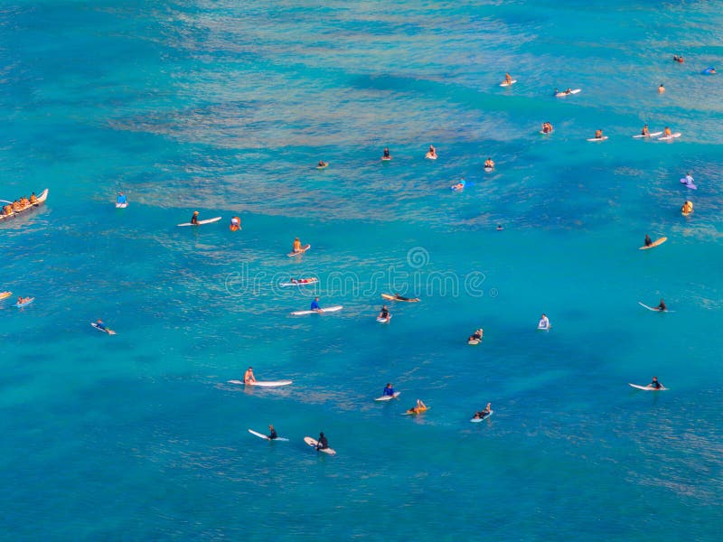 Surfers and Paddleboarders on Turquoise Waters Near Oahu, Hawaii stock images