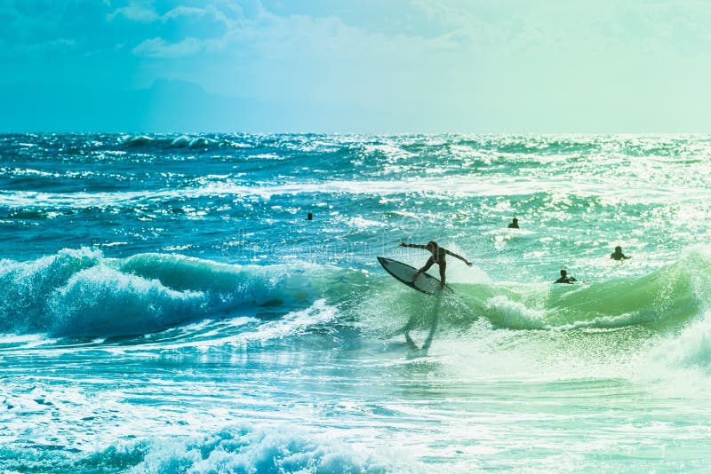 Surfers riding some waves on the sea stock photo Surfers riding some waves on the sea stock photo