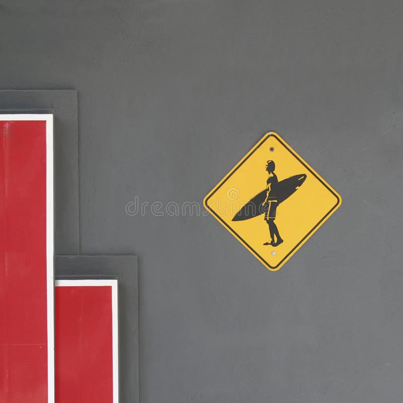 Surfing emblem on gray cement wall with red and white minimal elements royalty free stock photography