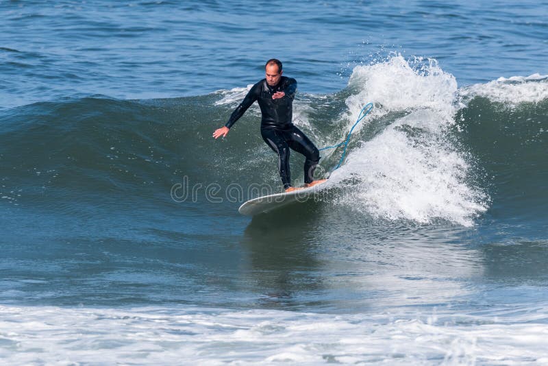 Surfing the waves stock image. Image of ocean, longboard 215230367