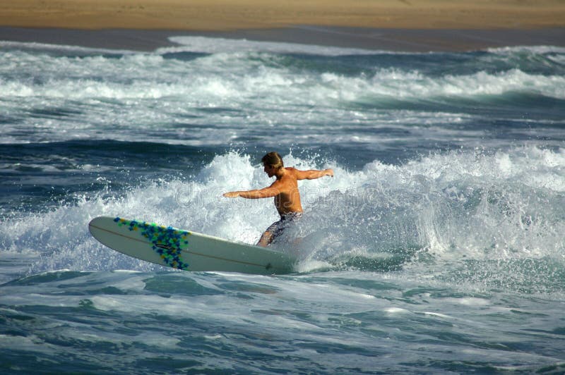 Longboard surfer cutting back on a wave. Longboard surfer cutting back on a wave