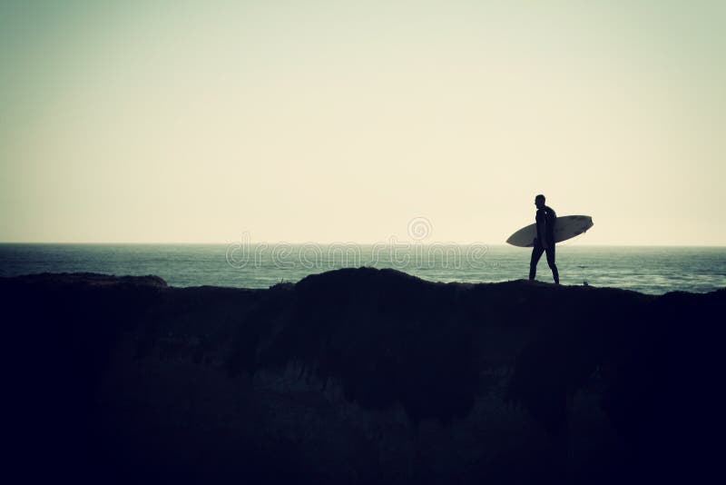 Surfer in Santa Cruz during sunset. Surfer in Santa Cruz during sunset.