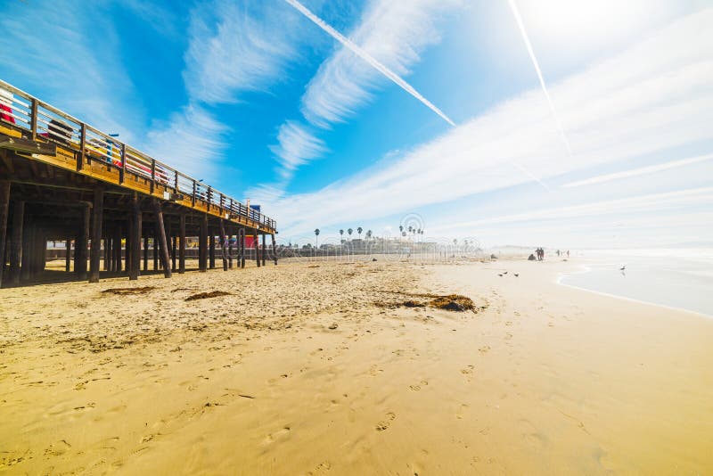 Surfer by Pismo Beach pier, California. Surfer by Pismo Beach pier, California