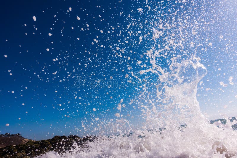 A surge of surf waves on a rocky shore