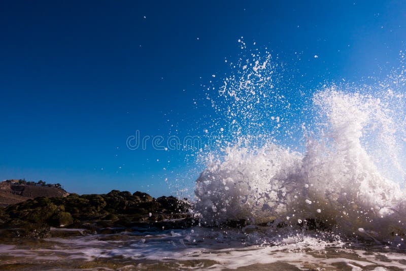 A surge of surf waves on a rocky shore