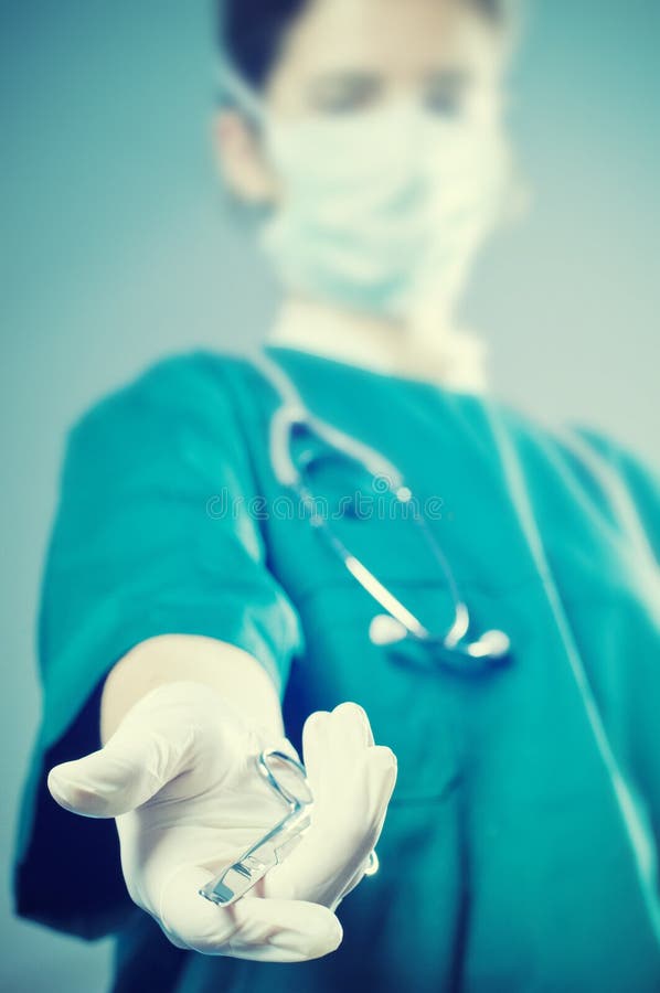 Surgeon medic with scissors. Surgeon medic with a scissors. Focus on scissors royalty free stock image
