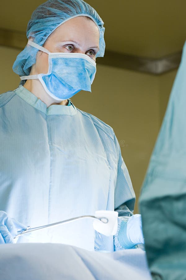 Surgeon performing operation stock photo