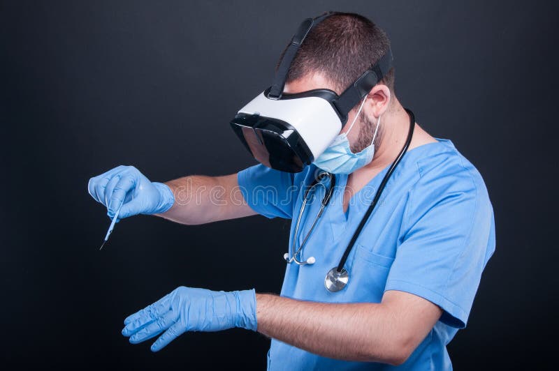 Surgeon using virtual reality glasses and bistoury stock images