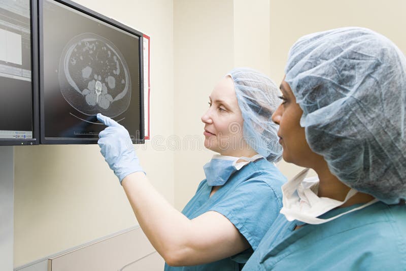 Surgeons looking at scan stock photography