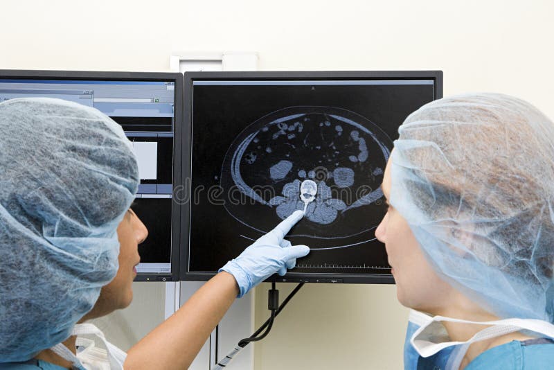 Surgeons looking at scan stock photos