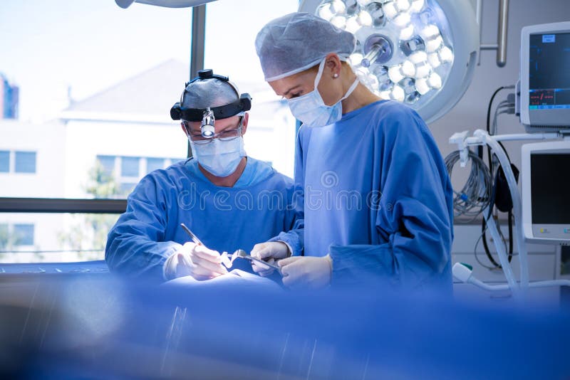 Surgeons Performing Operation In Operation Theater Stock Photo Image