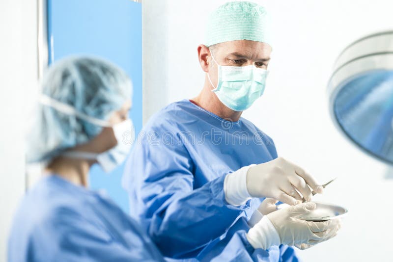 Surgeons at Work stock photo. Image of medical, three 18267376