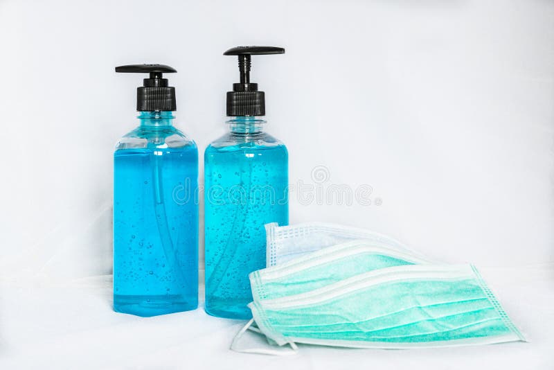 Surgical face masks and alcohol hand sanitizer gels for protecting covid-19 virus inflection on white background