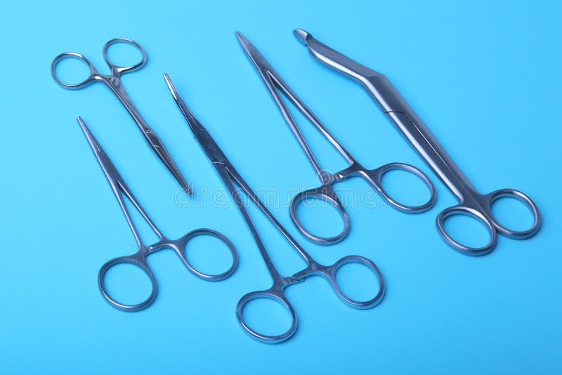 Surgical instruments and tools including scalpels, forceps and tweezers arranged on a table for a surgery. Surgical instruments and tools including scalpels stock photos Surgical instruments and tools including scalpels, forceps and tweezers arranged on a table for a surgery. Surgical instruments and tools including scalpels stock photos