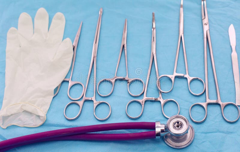 Surgical Instruments and Tools Including Scalpels, Forceps and Tweezers Arranged on a Table for
