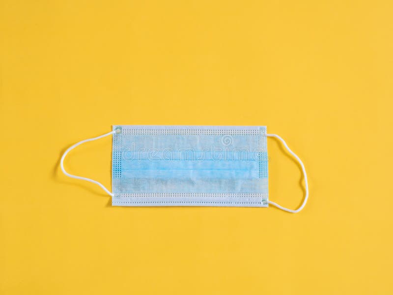 Surgical mask on yellow stock image. Image of protective 195930143