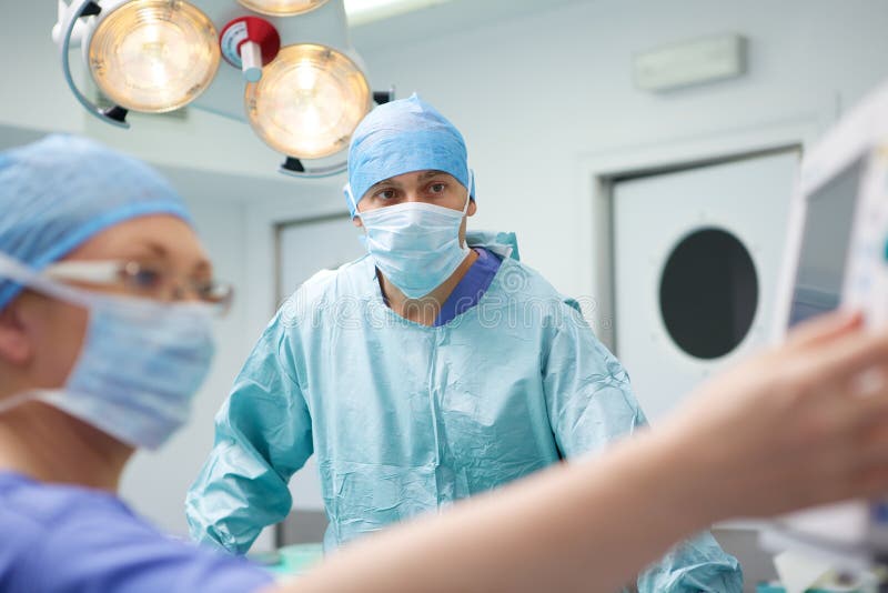Surgical team performing operation stock photo