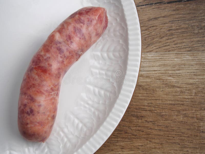 Raw creole sausage in plate. Raw creole sausage in plate