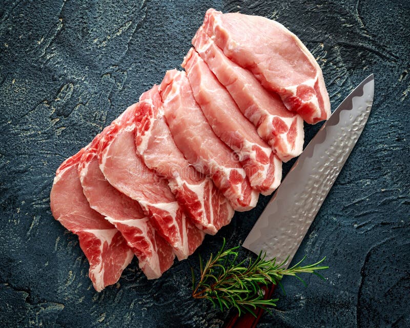 Surowy wieprzowiny Loin sieka z ziele, rozmarynami, macierzanką, pieprzem i nożem, fotografia stock Surowy wieprzowiny Loin sieka z ziele, rozmarynami, macierzanką, pieprzem i nożem, fotografia stock