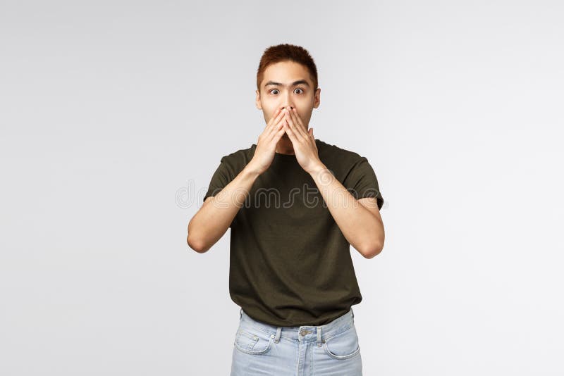 Surprised And Amused Asian Man Gasping Cover Mouth And Look Camera