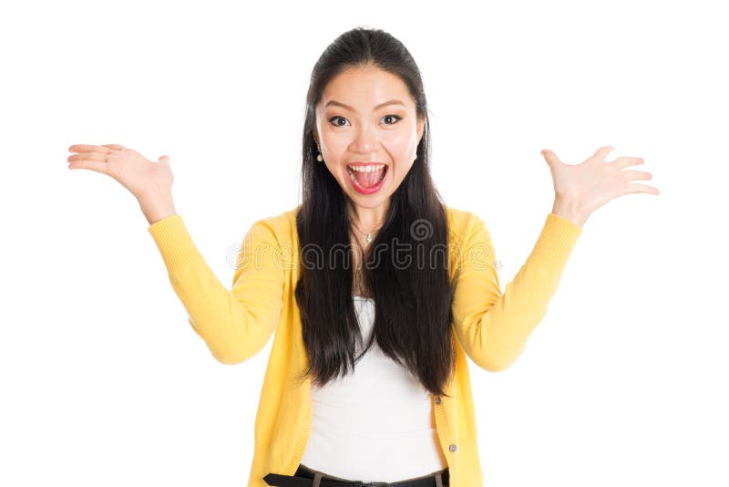 Surprised Asian girl mouth open wide, shouting and looking at camera, standing isolated on white background.