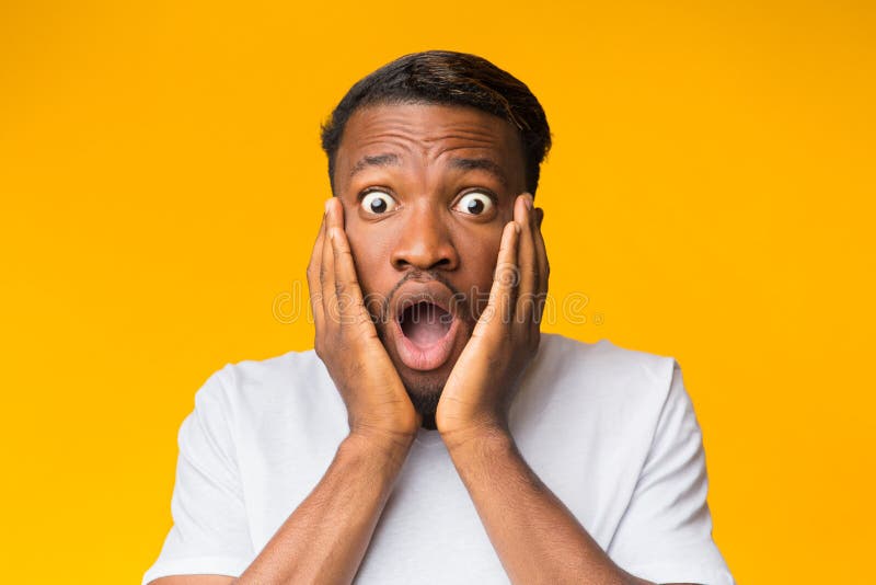 Surprised Black Man Touching Face Posing Over Orange Background