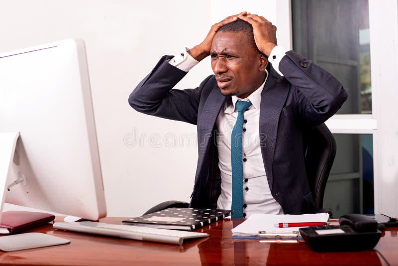 Young businessman surprised by seeing bad news on the computer in the office