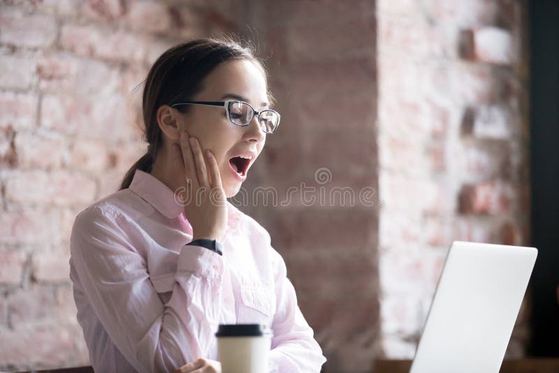 Surprised businesswoman with laptop excited because of win stock image