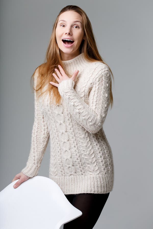 Surprised girl in long sweater royalty free stock photo