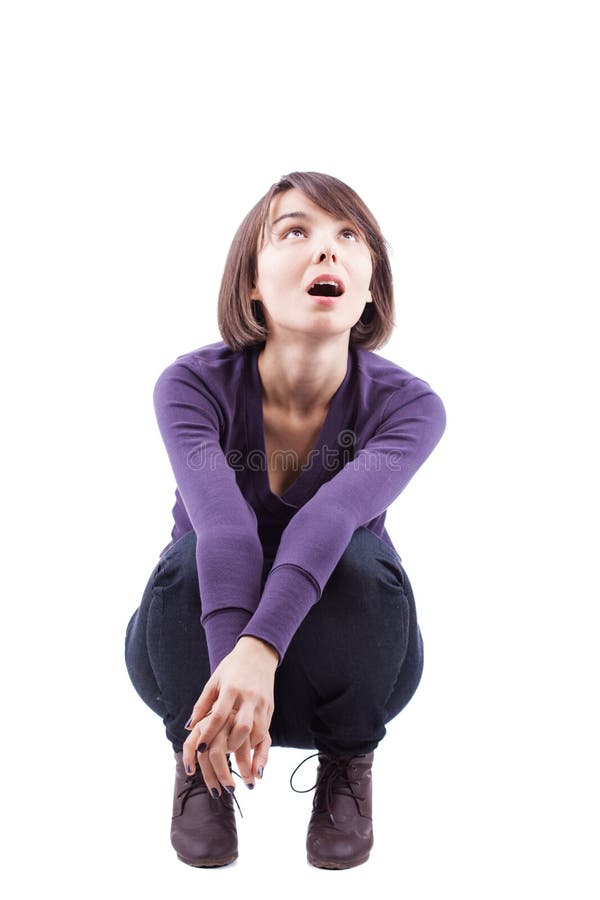 Crouching surprised girl with short hair