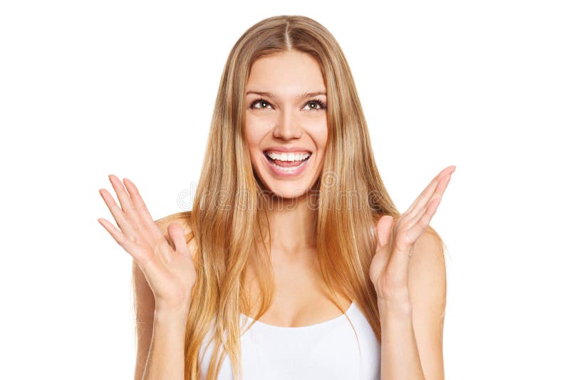 Surprised happy beautiful young woman looking up in excitement. Isolated over white