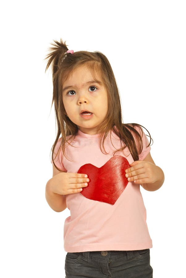 Surprised little girl holding heart