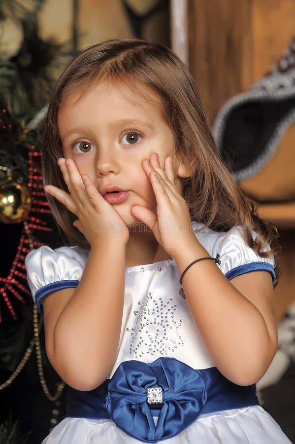 Surprised Little Girl Near The Christmas Tree Stock Photo 