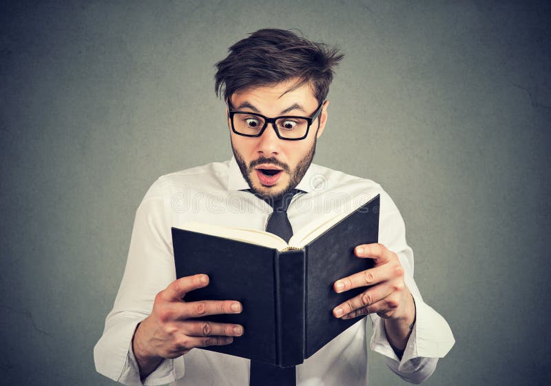 Surprised man exploring things from book royalty free stock images