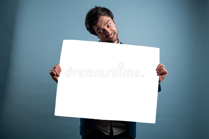Surprised man holding white advertising banner stock image