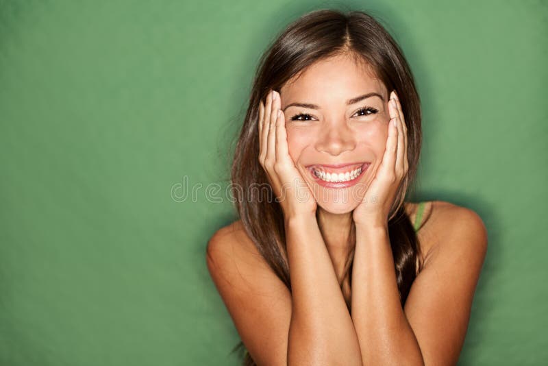 Surprised woman on green background.