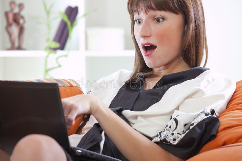 Surprised woman with laptop