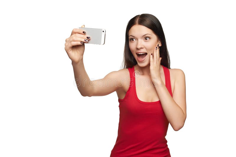 Surprised young girl taking selfie